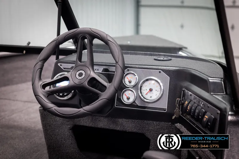 Slide: The Image of 2025 Lund 1775 Impact XS boat dashboard with steering wheel and gauges. - 24
