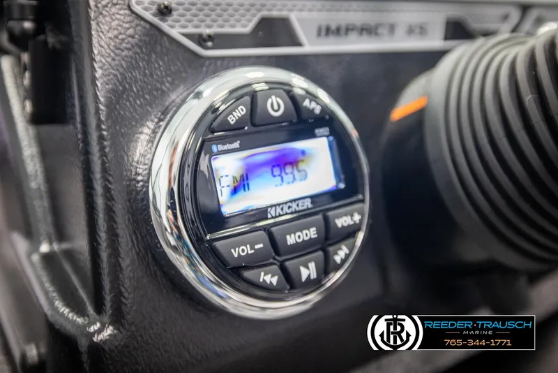 Slide: The Image of 2025 Lund 1775 Impact XS boat dashboard with Kicker audio system display. - 27