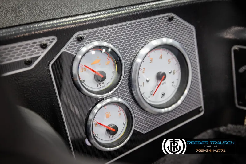 Slide: The Image of Dashboard gauges of 2025 Lund 1775 Impact XS boat, featuring trim and fuel indicators. - 28