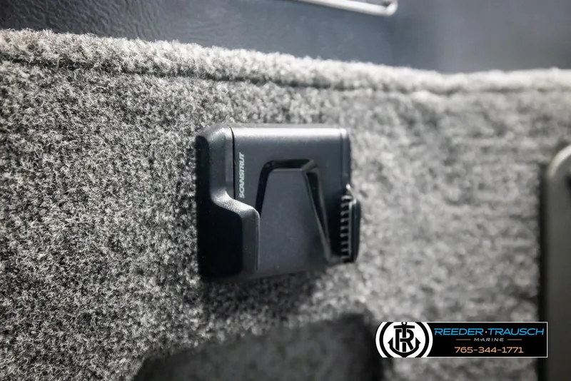 Slide: The Image of 2025 Lund 1775 Impact XS interior detail with carpeted surface and accessory clip. - 34