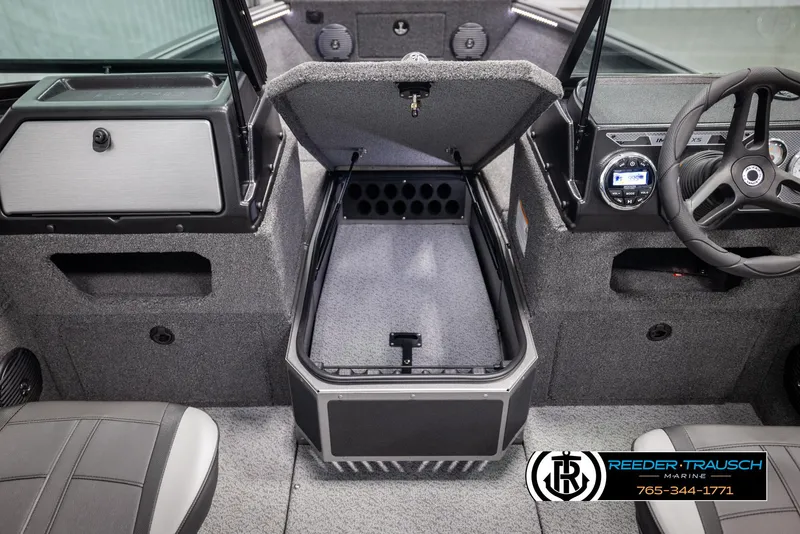 Slide: The Image of 2025 Lund 1775 Impact XS boat interior with open storage compartment and steering wheel. - 36