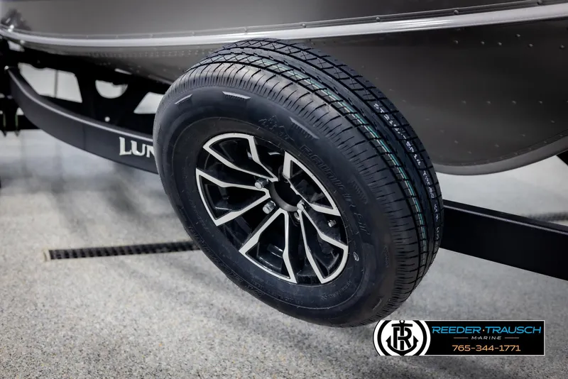 Slide: The Image of 2025 Lund 1775 Impact XS boat trailer wheel with sleek black alloy rim. - 47