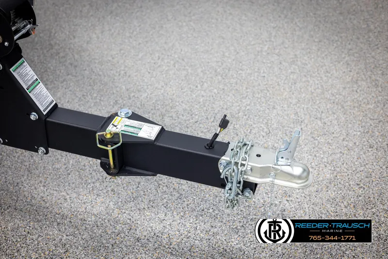 Slide: The Image of Trailer hitch of 2025 Lund 1775 Impact XS with safety chains on concrete surface. - 49