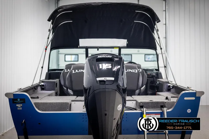 Slide: The Image of 2025 Lund 1775 Impact XS boat with Mercury 115 engine in showroom. - 7