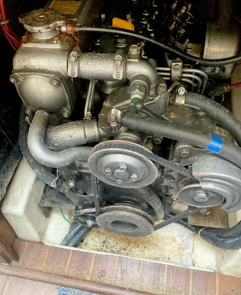 Slide: The Image of Engine of a 1983 Hunter 34 sailboat, showing belts and hoses. - 17