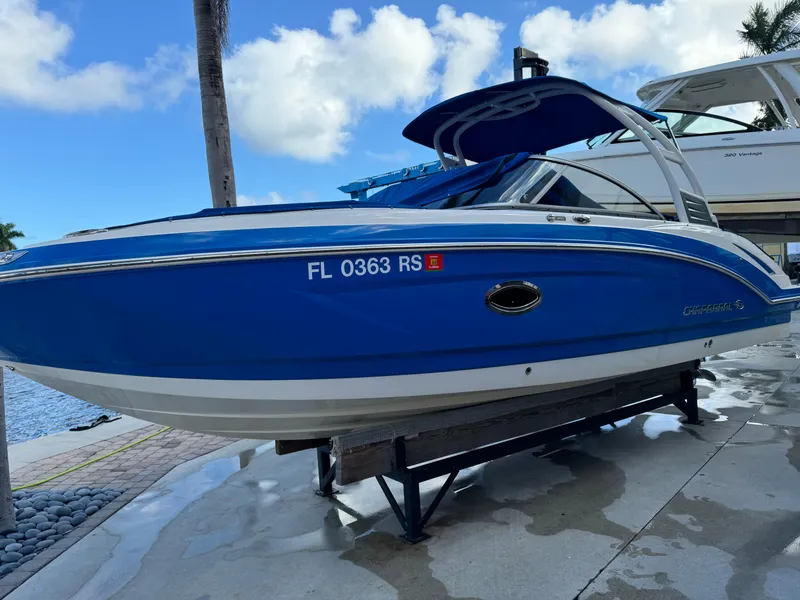 The Image of 2017 Chaparral 250 Suncoast boat in vibrant blue, docked on a sunny day. - 0