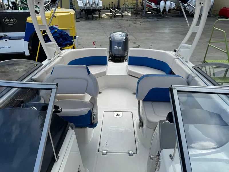 Slide: The Image of 2017 Chaparral 250 Suncoast boat interior with blue and white seating. - 10