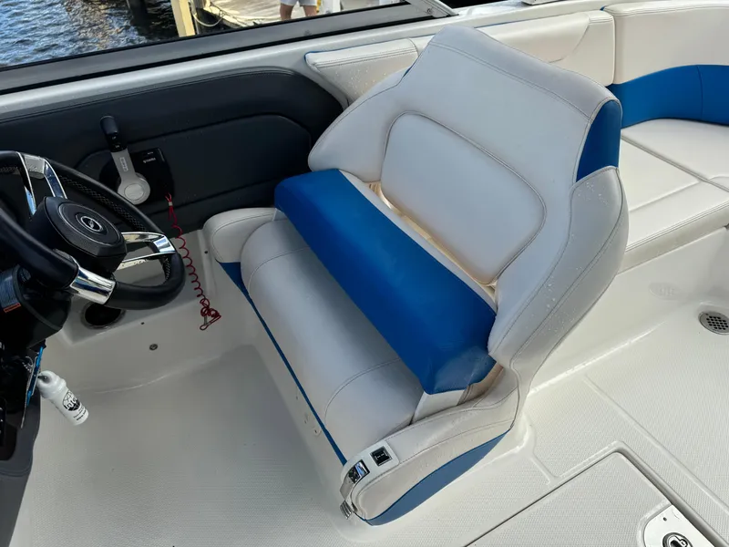 Slide: The Image of 2017 Chaparral 250 Suncoast boat interior with white and blue seating. - 13