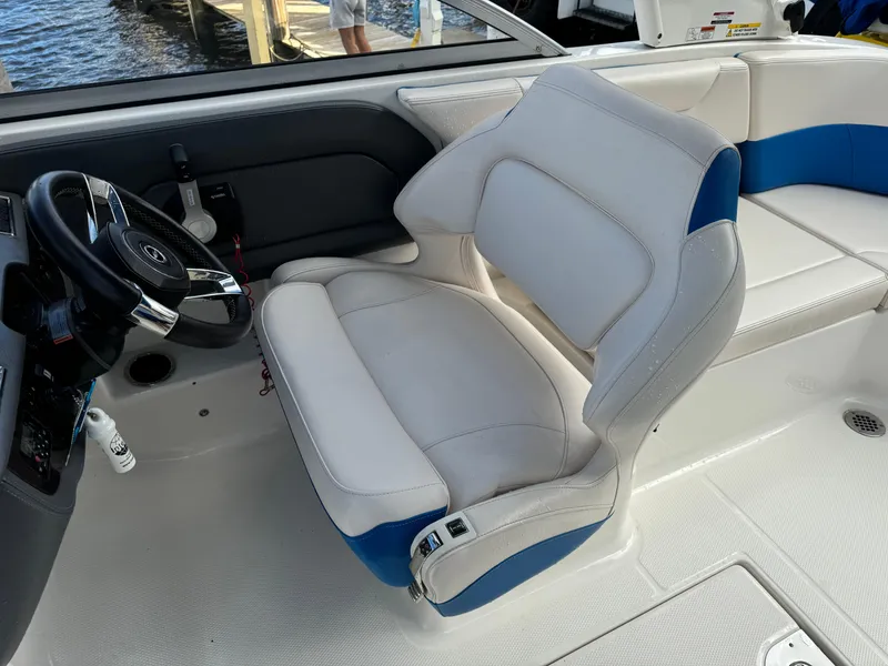 Slide: The Image of 2017 Chaparral 250 Suncoast boat interior with white and blue captain's seat. - 14