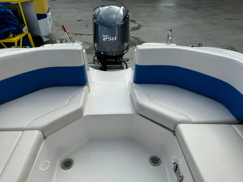 Slide: The Image of 2017 Chaparral 250 Suncoast boat interior with Yamaha 250 engine, featuring white and blue seating. - 19