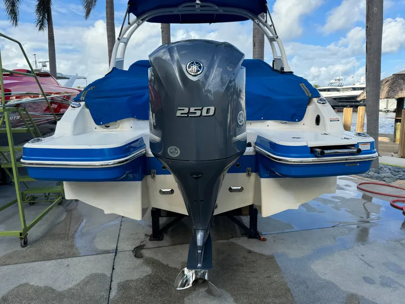 Slide: The Image of 2017 Chaparral 250 Suncoast boat with Yamaha outboard motor, docked on a sunny day. - 2