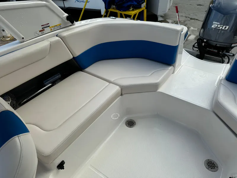 Slide: The Image of 2017 Chaparral 250 Suncoast boat interior with white and blue seating. - 20