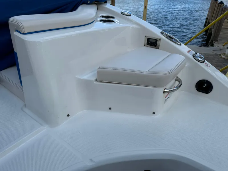 Slide: The Image of 2017 Chaparral 250 Suncoast boat seating area with white upholstery and cup holders. - 23