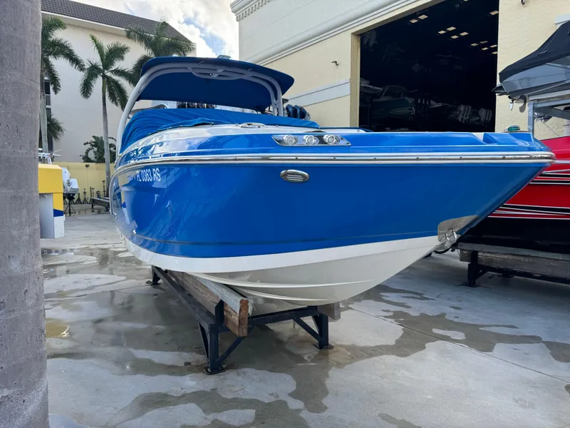 Slide: The Image of 2017 Chaparral 250 Suncoast boat in vibrant blue, docked outdoors. - 4