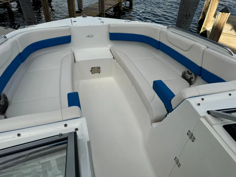Slide: The Image of 2017 Chaparral 250 Suncoast boat interior with white and blue seating. - 7