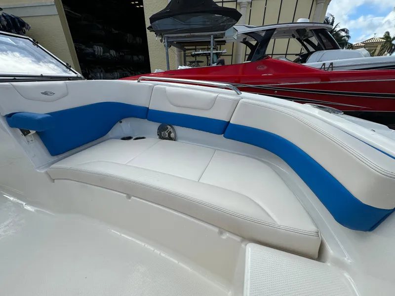 Slide: The Image of 2017 Chaparral 250 Suncoast boat interior with white and blue seating. - 9