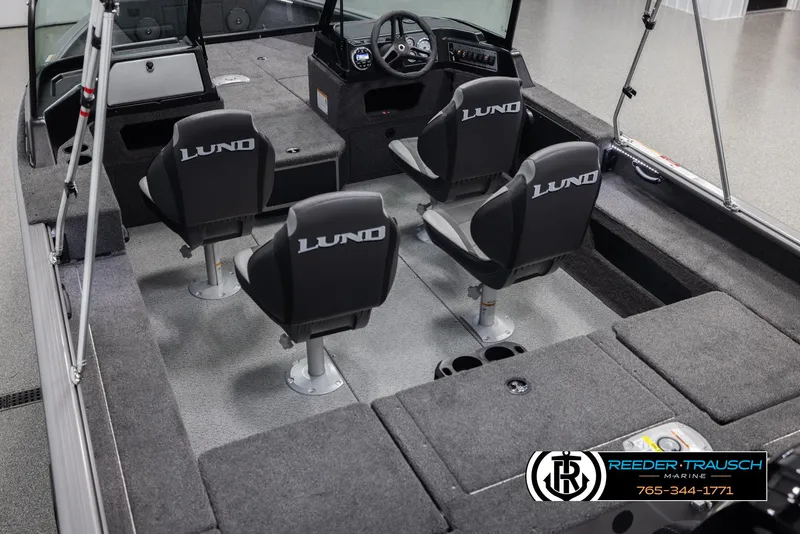 Slide: The Image of 2025 Lund 1875 Impact XS boat interior with four seats and fishing rod holders. - 10