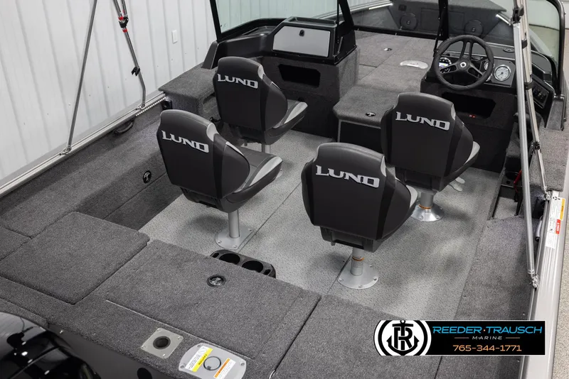 Slide: The Image of 2025 Lund 1875 Impact XS boat interior with four seats and steering console. - 11