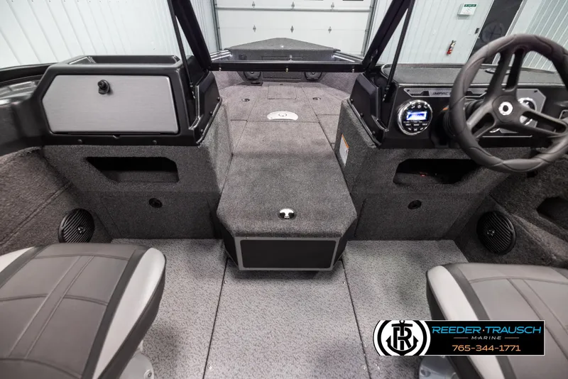 Slide: The Image of Interior of 2025 Lund 1875 Impact XS boat, featuring steering wheel and seating. - 13