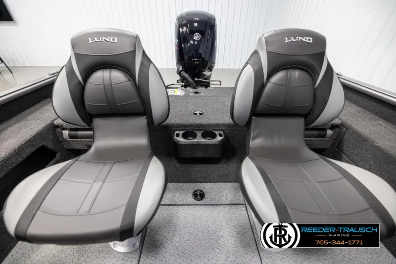 Slide: The Image of 2025 Lund 1875 Impact XS boat interior with two gray seats and motor. - 17