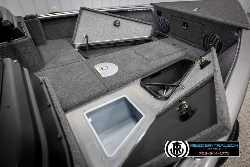 Slide: The Image of 2025 Lund 1875 Impact XS boat interior with open storage compartments and speakers. - 19