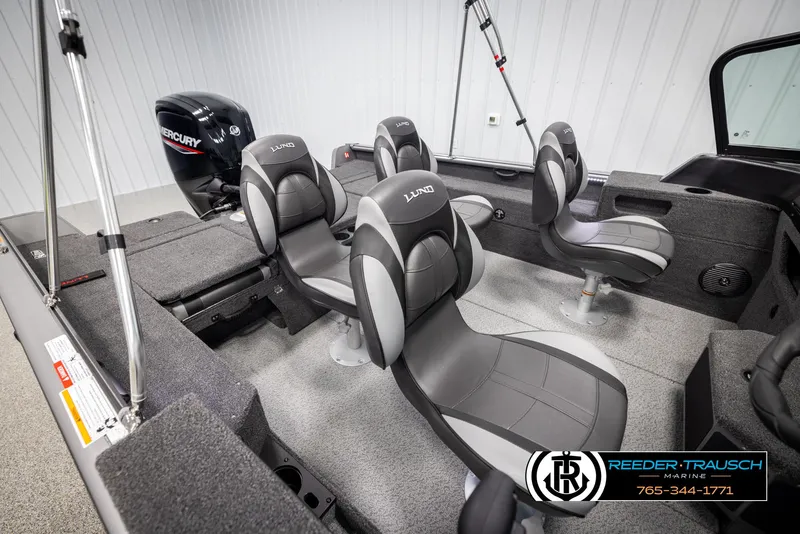 Slide: The Image of 2025 Lund 1875 Impact XS boat interior with four gray seats and Mercury engine. - 20