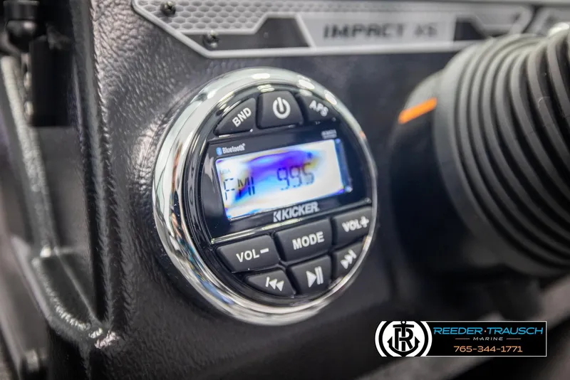 Slide: The Image of 2025 Lund 1875 Impact XS dashboard with Kicker audio system displaying FM 99.5. - 25