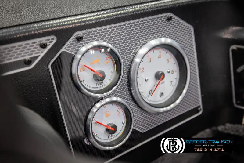 Slide: The Image of Dashboard gauges of 2025 Lund 1875 Impact XS boat, featuring trim and fuel indicators. - 29