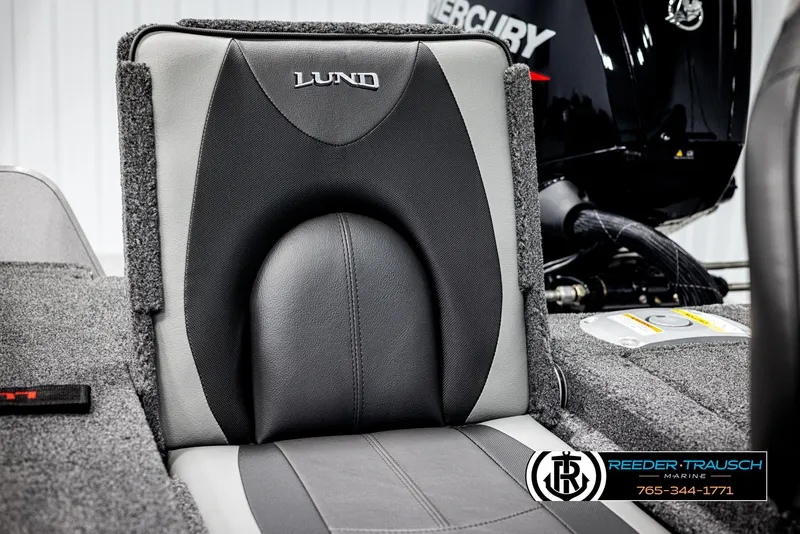 Slide: The Image of 2025 Lund 1875 Impact XS boat seat with Mercury engine in background. - 31