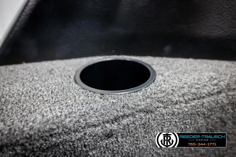 Slide: The Image of Carpeted interior detail of 2025 Lund 1875 Impact XS boat, featuring a circular cutout. - 35