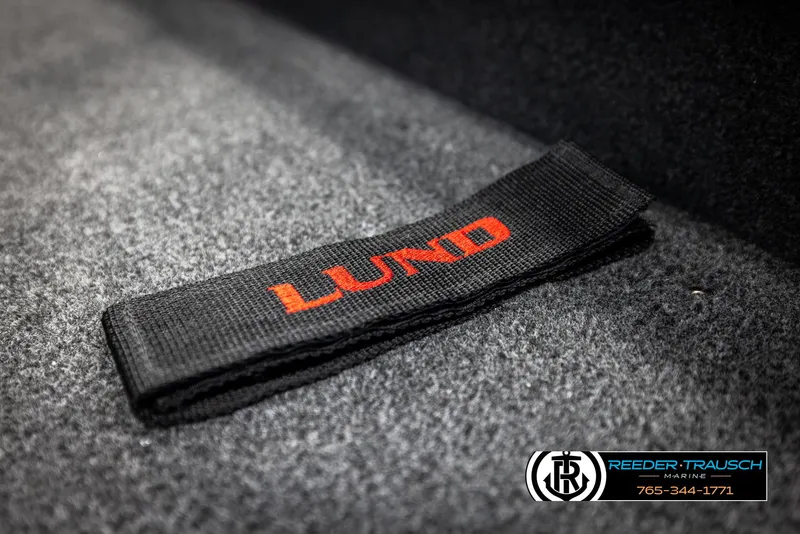 Slide: The Image of Black strap with red "Lund" logo on carpet, 2025 Lund 1875 Impact XS boat. - 38
