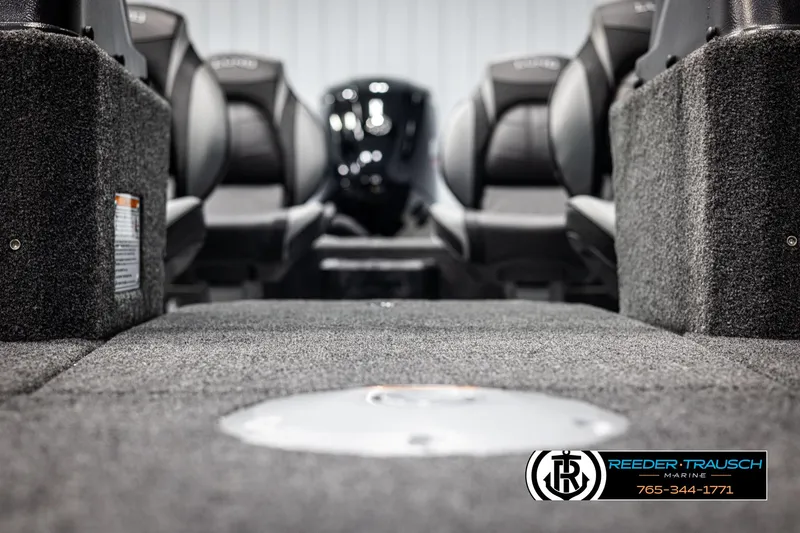Slide: The Image of 2025 Lund 1875 Impact XS interior with carpeted flooring and seating, Reeder-Trausch Marine logo visible. - 39