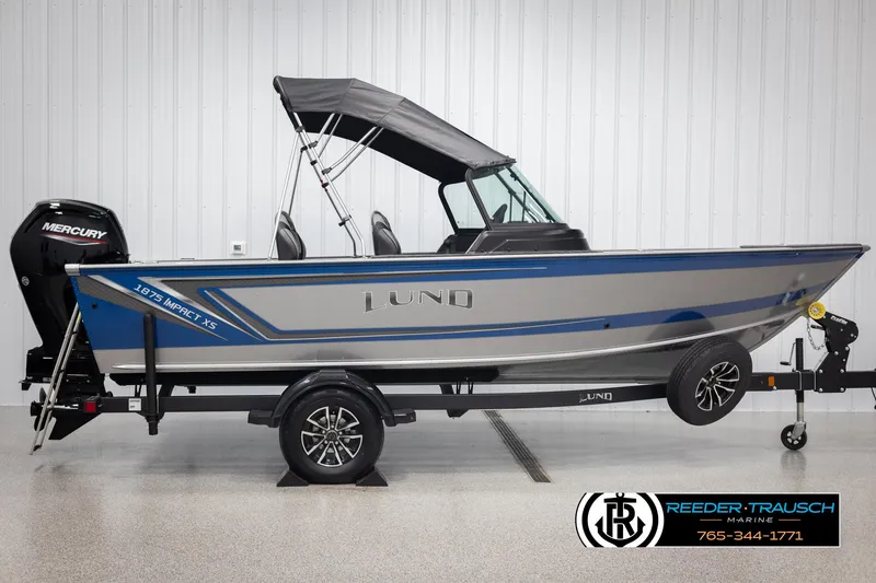 Slide: The Image of 2025 Lund 1875 Impact XS boat with Mercury engine on trailer in showroom. - 4