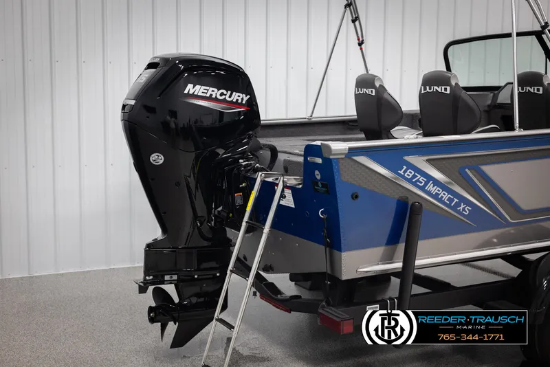 Slide: The Image of 2025 Lund 1875 Impact XS boat with Mercury outboard motor in showroom. - 40