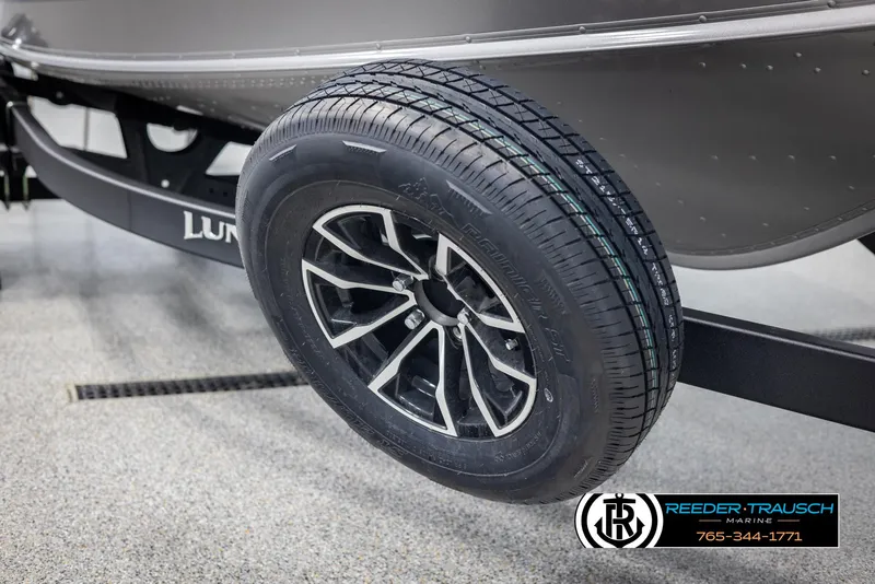 Slide: The Image of 2025 Lund 1875 Impact XS boat trailer wheel, featuring sleek black and silver design. - 46