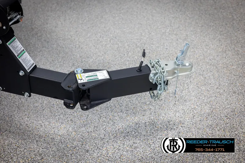 Slide: The Image of Trailer hitch of 2025 Lund 1875 Impact XS with safety chains on concrete floor. - 49
