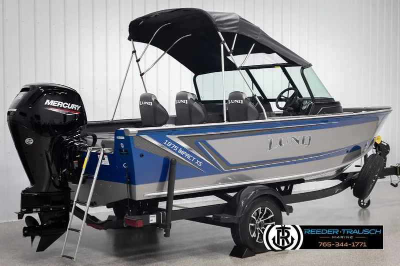 Slide: The Image of 2025 Lund 1875 Impact XS boat with Mercury engine, blue and silver design, on trailer. - 5