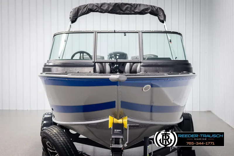 Slide: The Image of 2025 Lund 1875 Impact XS boat in showroom, front view, on trailer. - 7