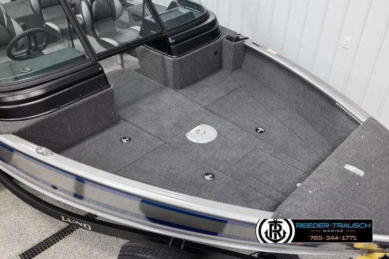 Slide: The Image of 2025 Lund 1875 Impact XS boat interior with spacious seating and carpeted deck. - 8