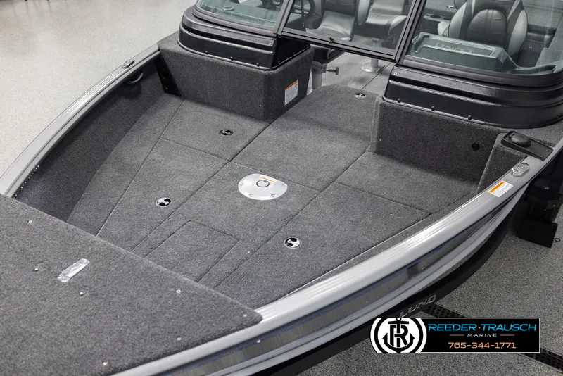 Slide: The Image of 2025 Lund 1875 Impact XS boat interior with carpeted deck and seating. - 9
