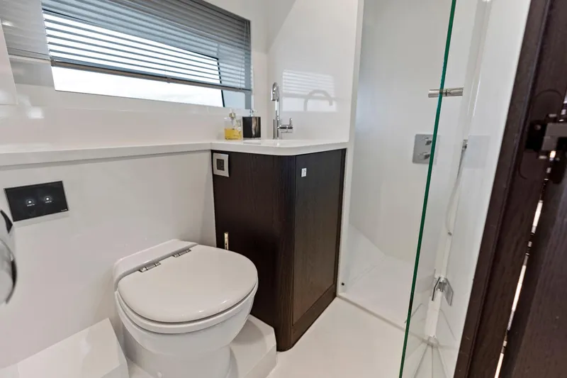 Slide: The Image of Luxurious bathroom in 2021 Sichterman Libertas 54 yacht with modern fixtures and glass shower. - 19