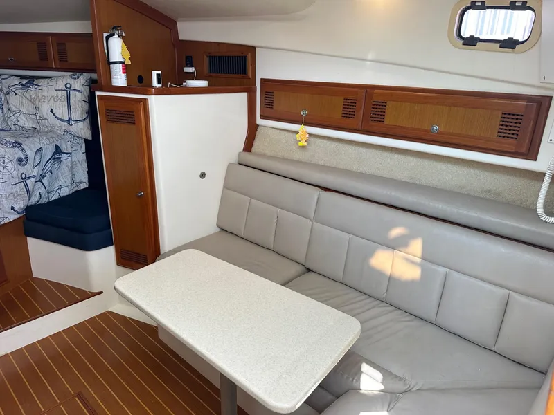 Slide: The Image of Interior of 2000 Cabo 31 Express boat with beige seating and wooden accents. - 14