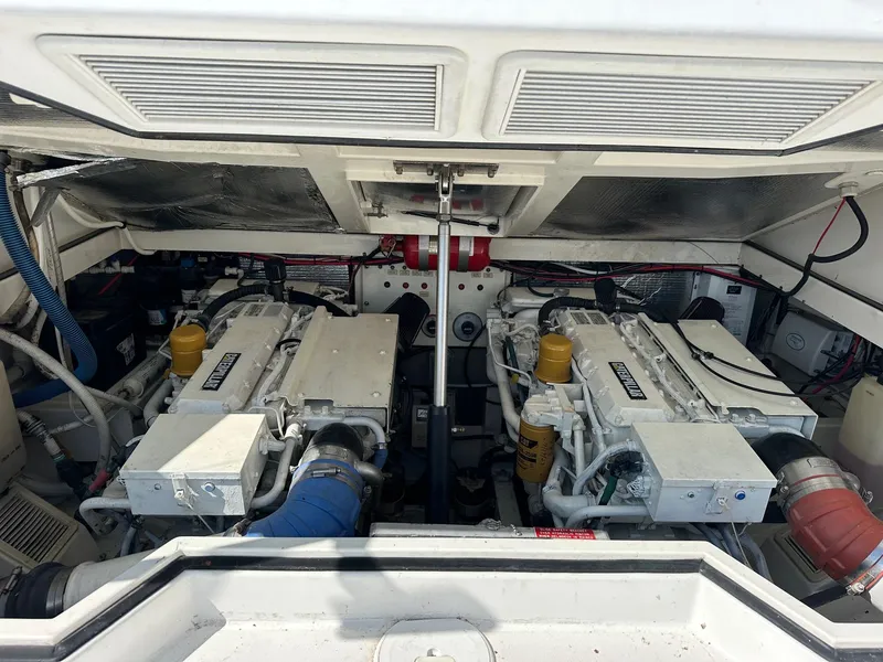 Slide: The Image of Engine compartment of 2000 Cabo 31 Express boat, featuring dual engines. - 19