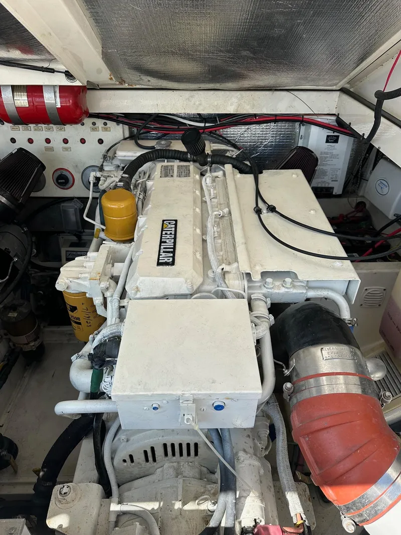 Slide: The Image of Engine compartment of a 2000 Cabo 31 Express boat, featuring a well-maintained diesel engine. - 20
