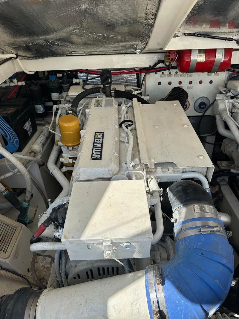 Slide: The Image of Engine compartment of a 2000 Cabo 31 Express boat, featuring detailed components. - 21