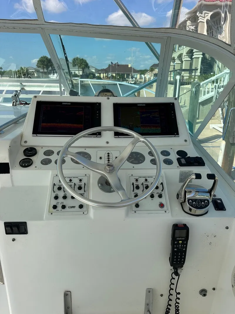 Slide: The Image of Helm of 2000 Cabo 31 Express boat with navigation controls and steering wheel. - 4