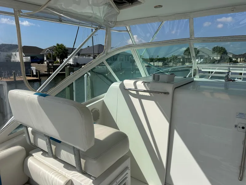 Slide: The Image of Interior of 2000 Cabo 31 Express boat with white seating and clear windows. - 6