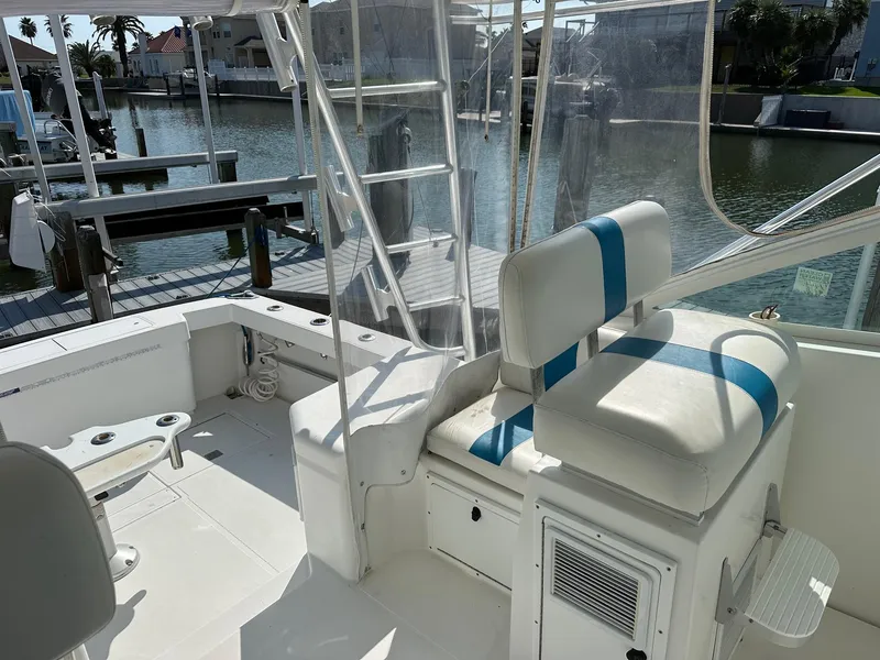 Slide: The Image of Cabo 31 Express 2000 boat interior with seating and dock view. - 8