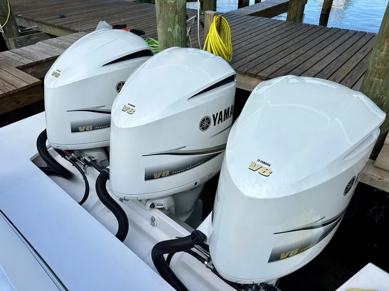 Slide: The Image of Triple Yamaha V8 outboard engines on 2021 Regal 38 SAV boat at dock. - 13