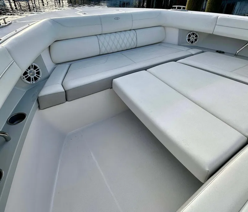 Slide: The Image of Luxurious seating area on 2021 Regal 38 SAV boat with white upholstery. - 15